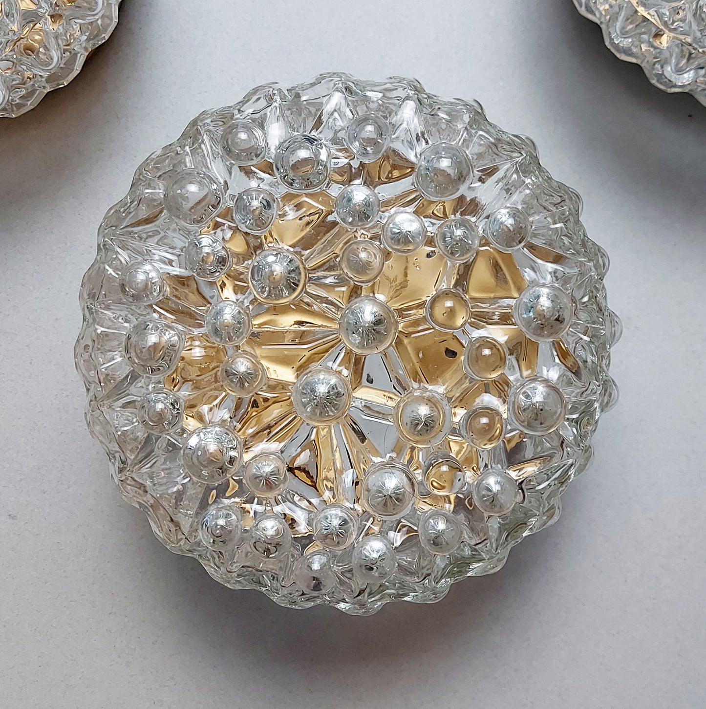 One of 3 1970s sconces or ceiling lights with bubble glass shades and gold painted metal base from Limburg - Retro Lamp Shop