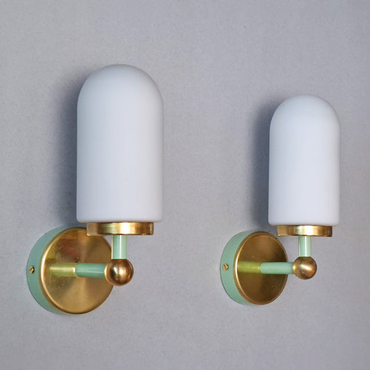 This is a pair of 1980s brass sconces with mint green accents and white frosted opaline shades - Retro Lamp Shop -
