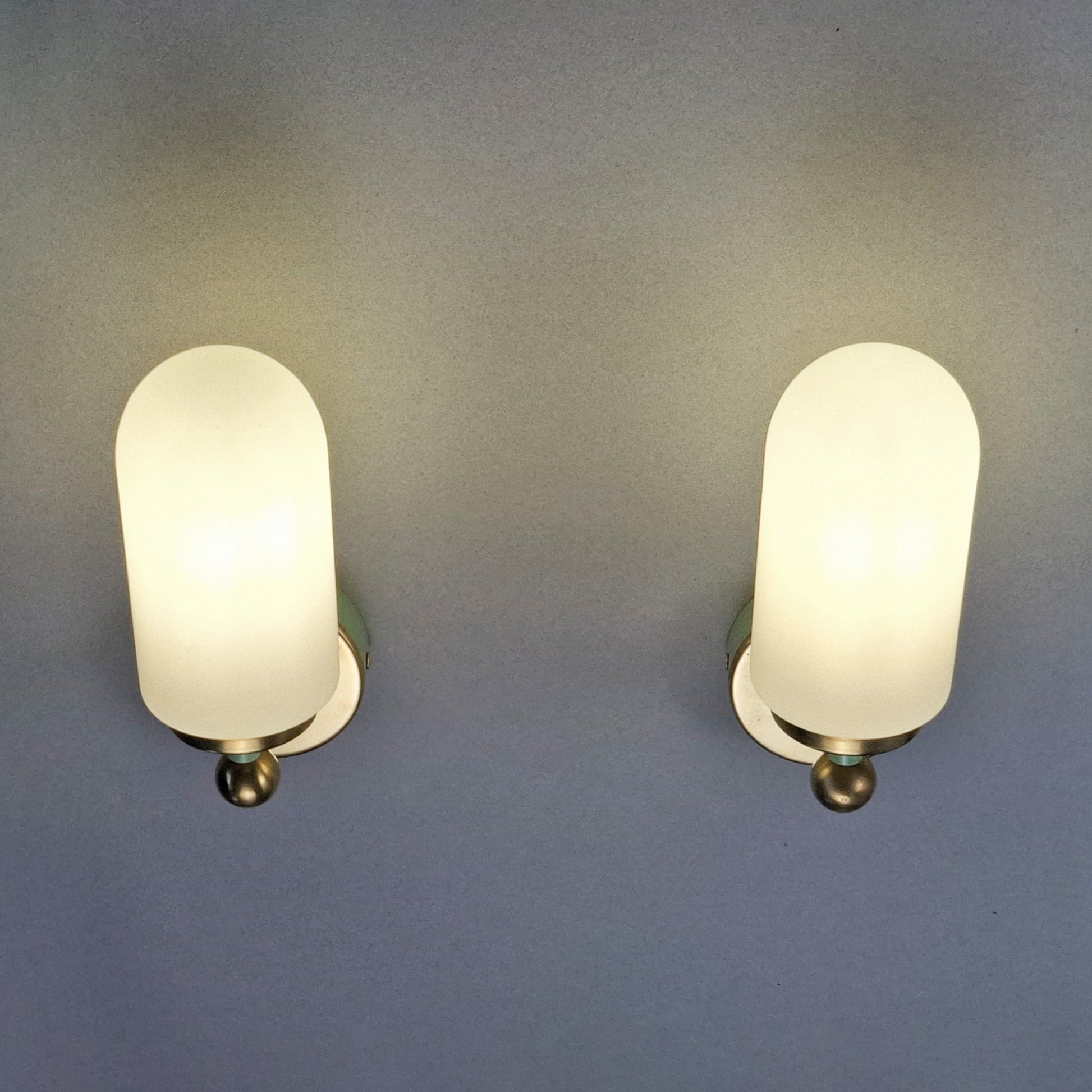 This is a pair of 1980s brass sconces with mint green accents and white frosted opaline shades - Retro Lamp Shop -