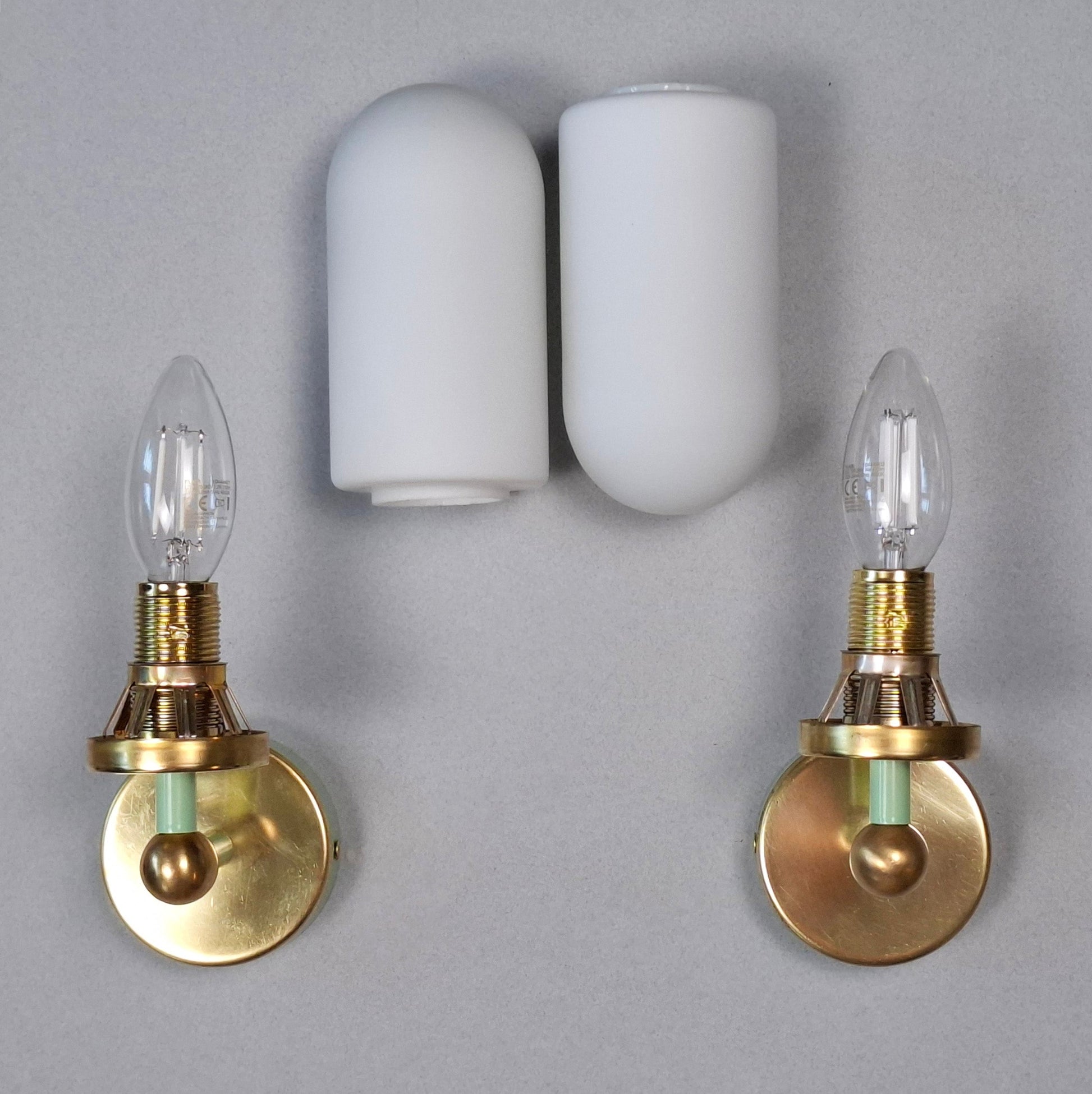This is a pair of 1980s brass sconces with mint green accents and white frosted opaline shades - Retro Lamp Shop -