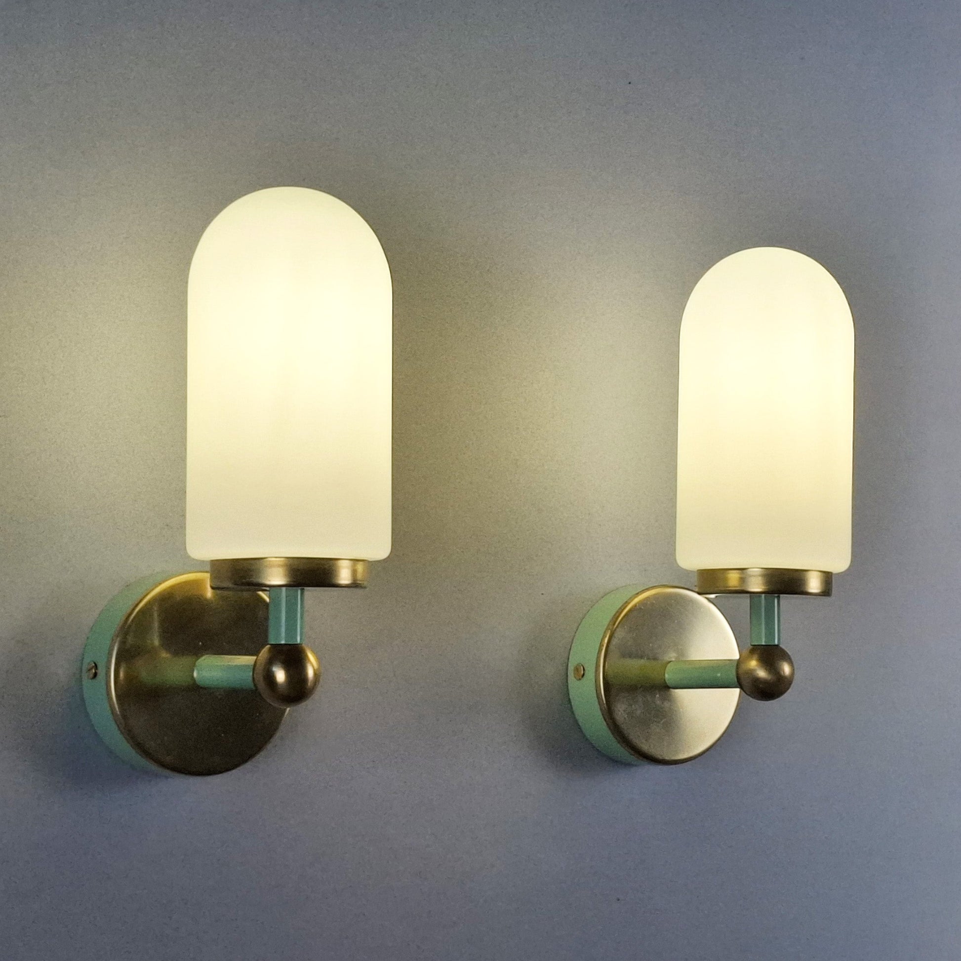 This is a pair of 1980s brass sconces with mint green accents and white frosted opaline shades - Retro Lamp Shop -