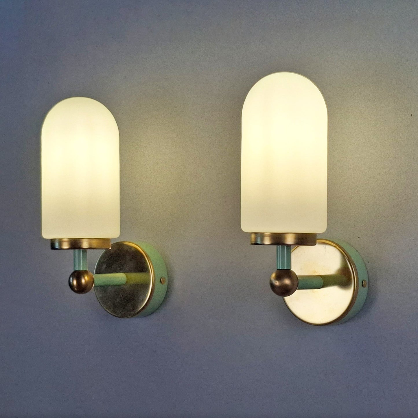 This is a pair of 1980s brass sconces with mint green accents and white frosted opaline shades - Retro Lamp Shop -
