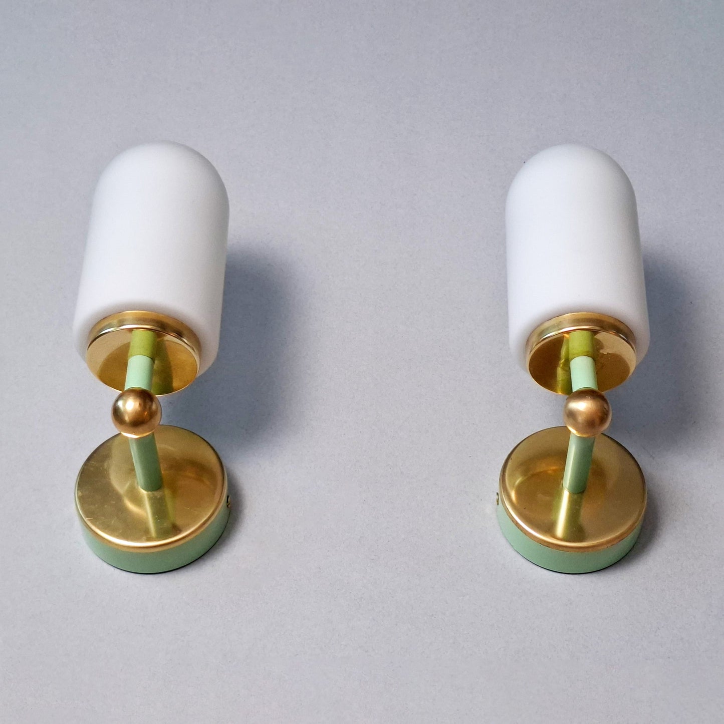 This is a pair of 1980s brass sconces with mint green accents and white frosted opaline shades - Retro Lamp Shop -