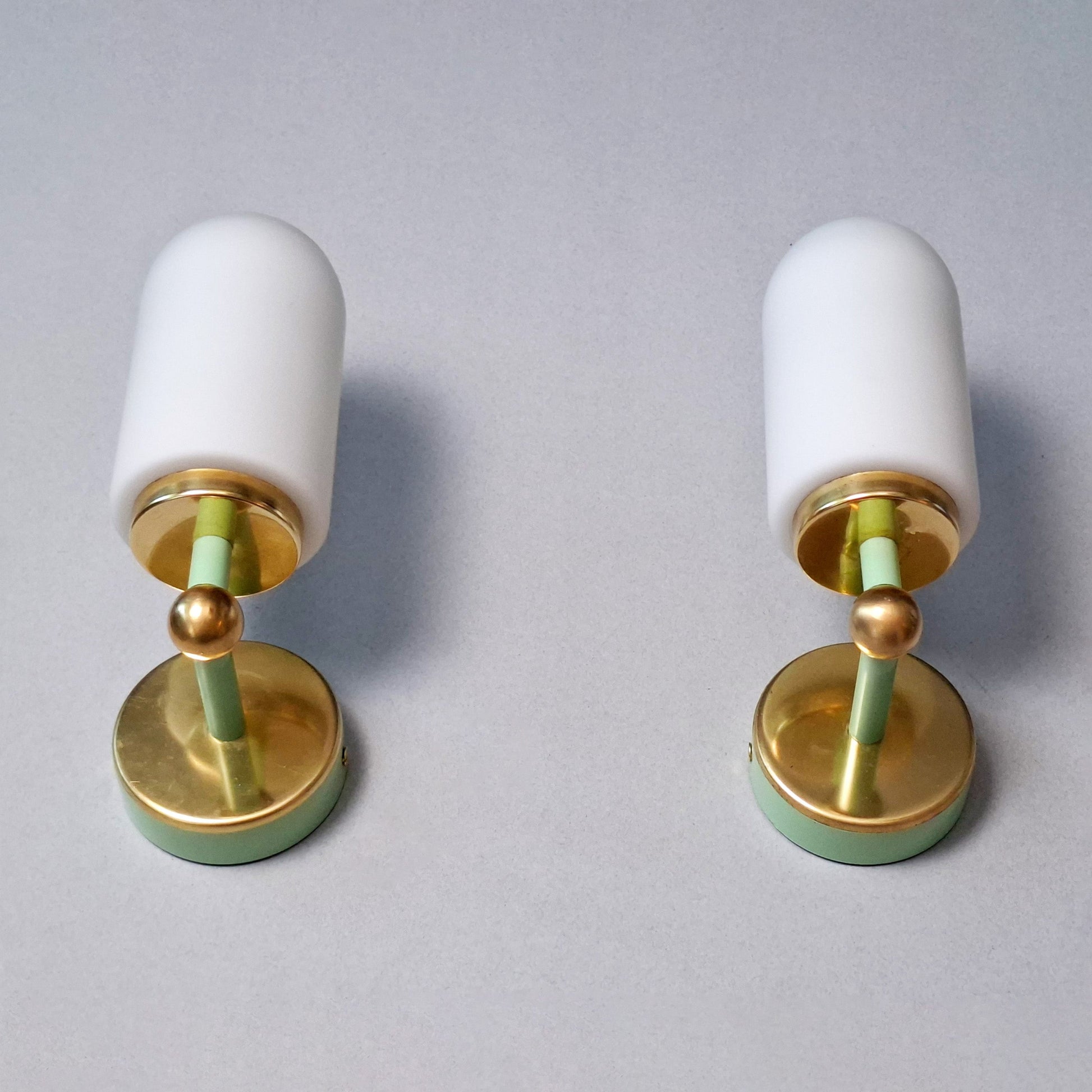 This is a pair of 1980s brass sconces with mint green accents and white frosted opaline shades - Retro Lamp Shop -