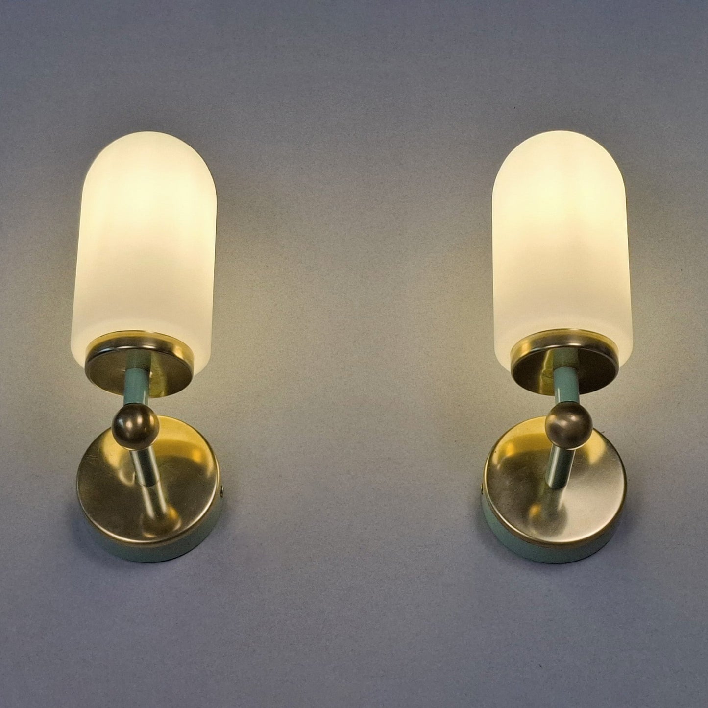 This is a pair of 1980s brass sconces with mint green accents and white frosted opaline shades - Retro Lamp Shop -