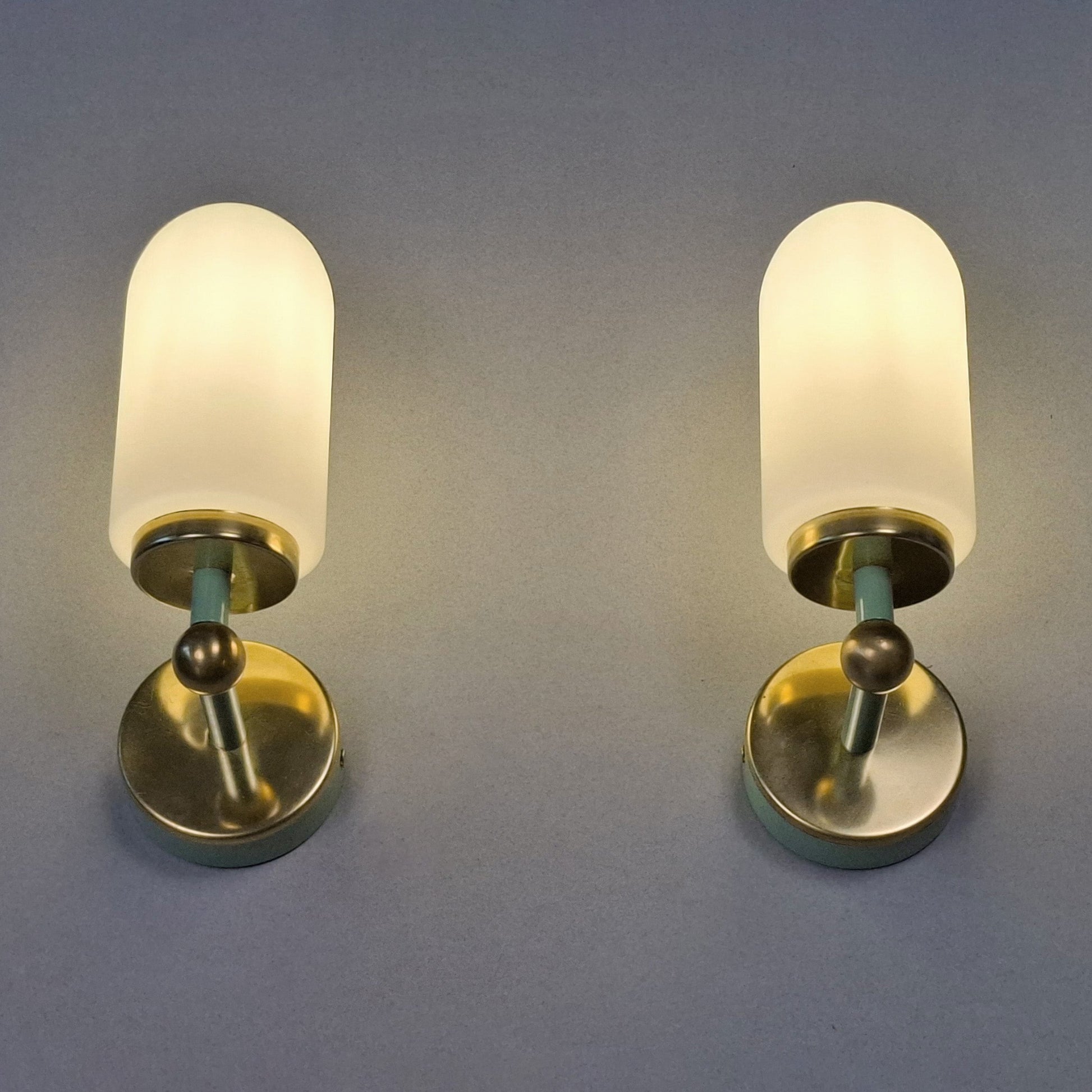 This is a pair of 1980s brass sconces with mint green accents and white frosted opaline shades - Retro Lamp Shop -