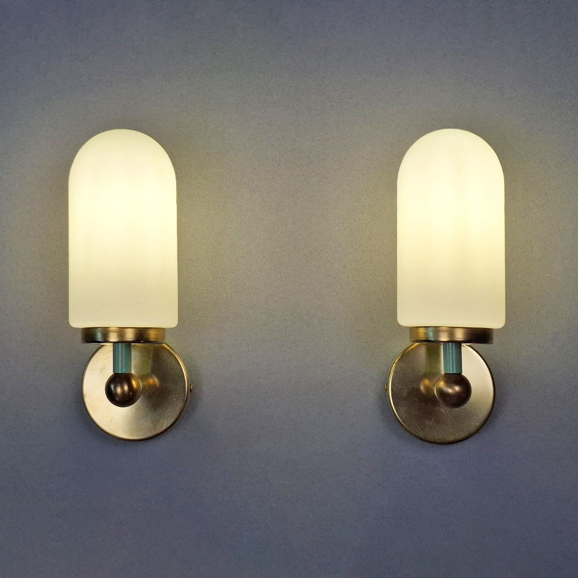 This is a pair of 1980s brass sconces with mint green accents and white frosted opaline shades - Retro Lamp Shop -