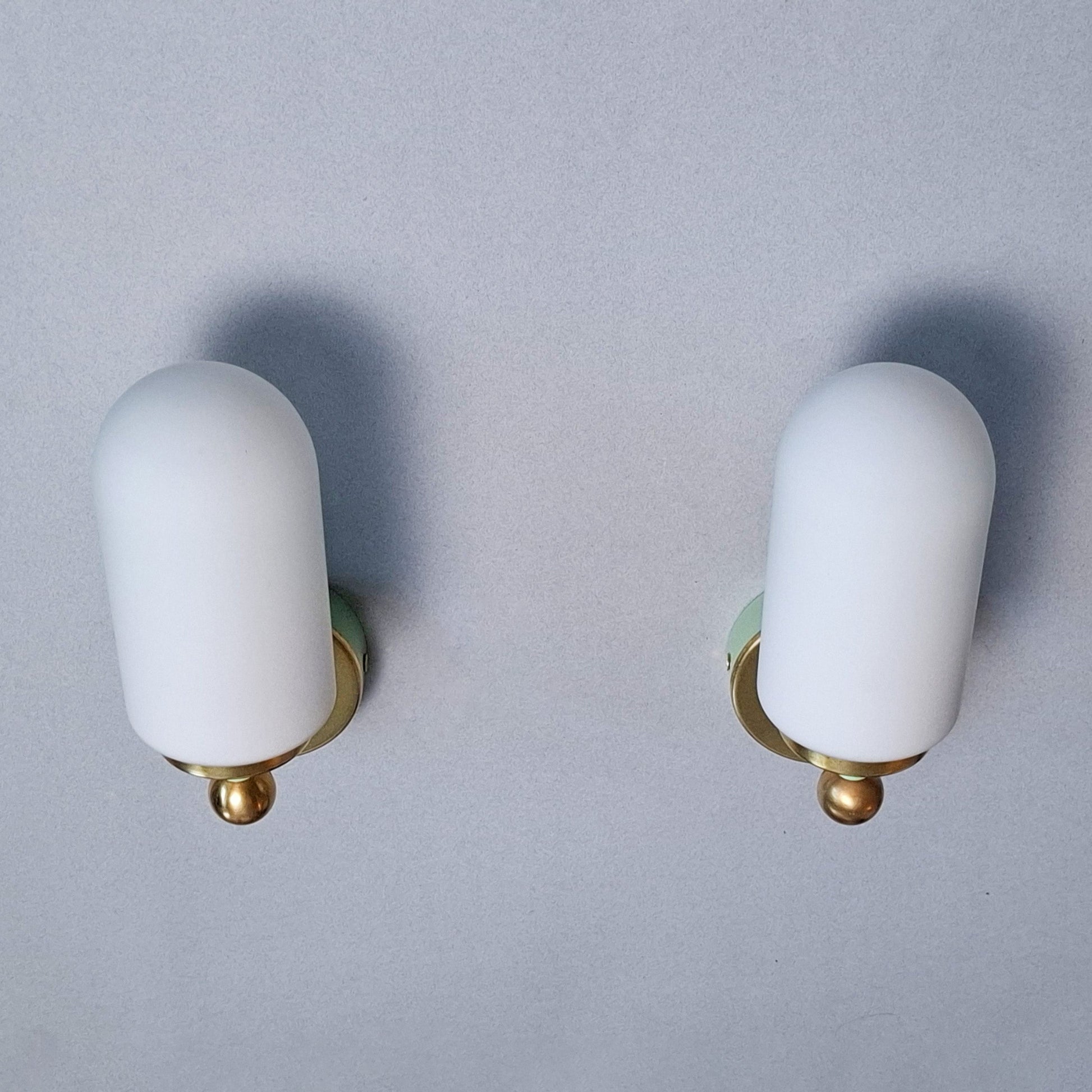 This is a pair of 1980s brass sconces with mint green accents and white frosted opaline shades - Retro Lamp Shop -